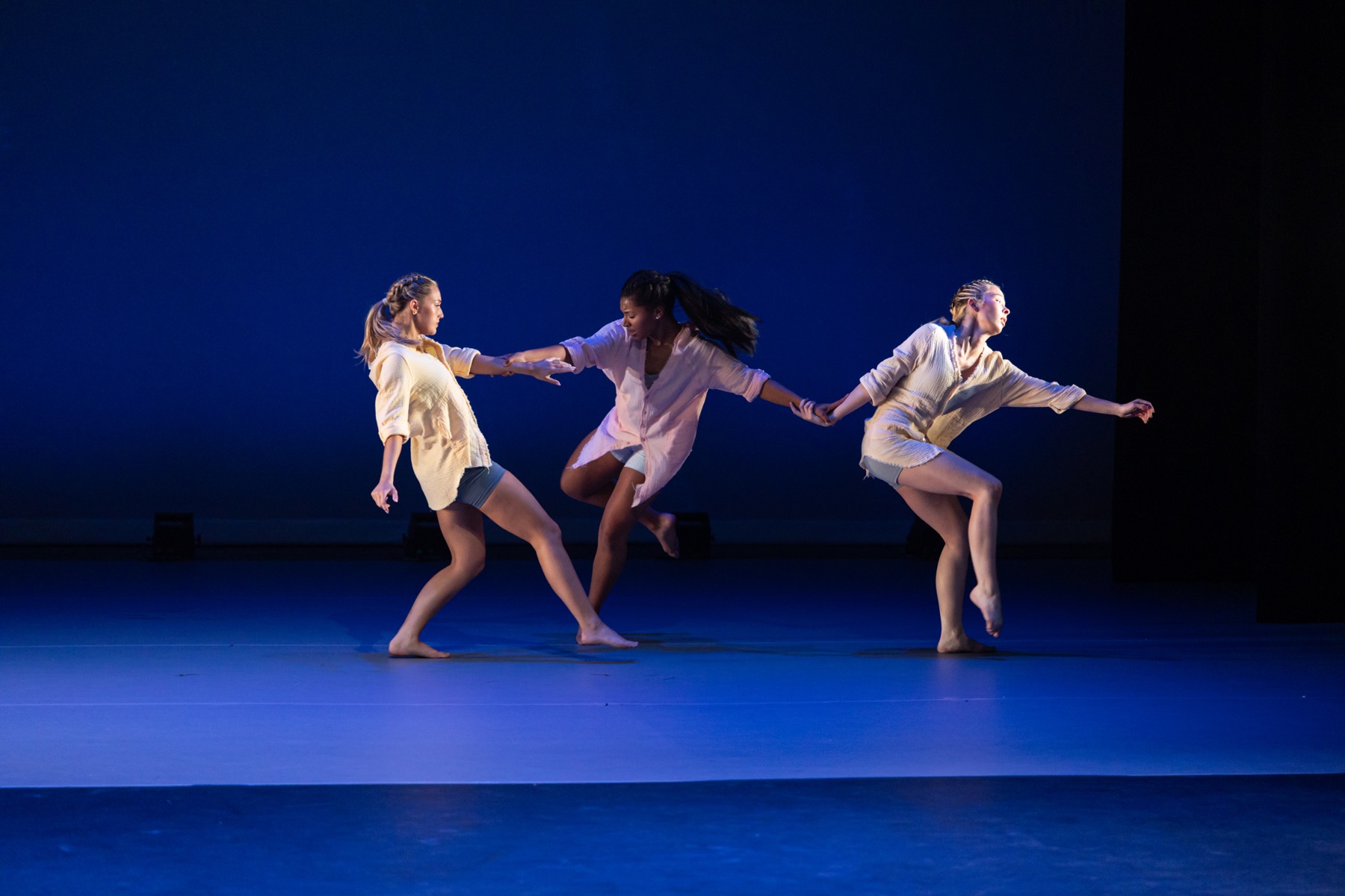 Falling Down trio moving across the stage in connected formation
