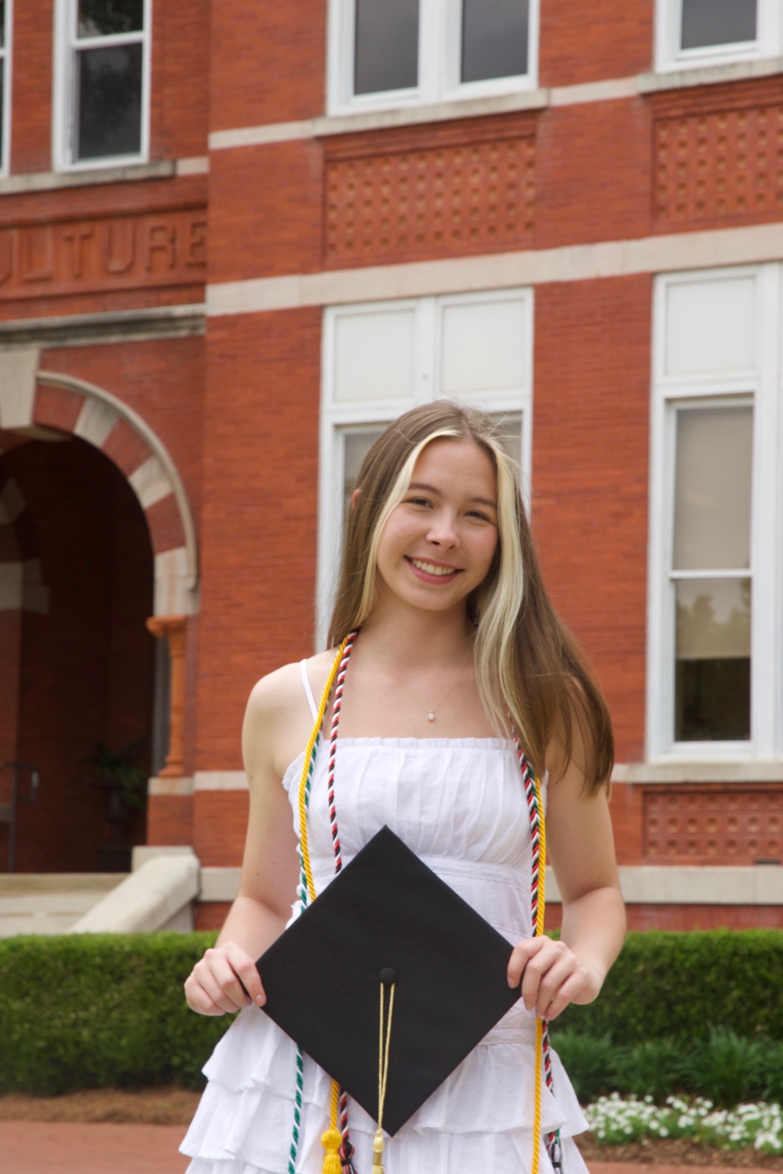 Liz Koifman smiling in front of a brick building
